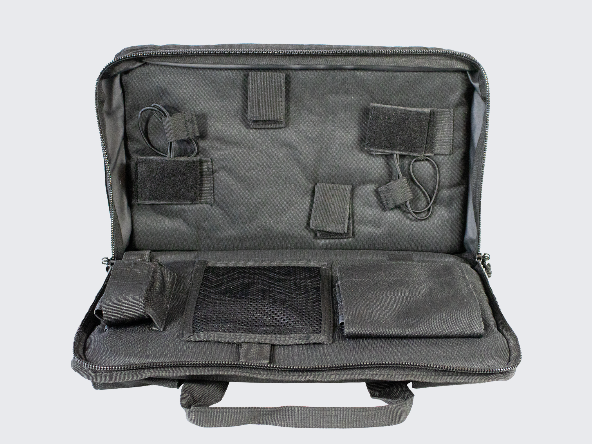 Musta aselaukku kahdelle pistoolille, lippaille sekä muille tarvikkeille. Black cun case for two pistols, pistol magazines and other equipments.